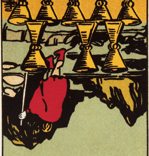 Image is upside-down: A figure walks away from 8 upright cups toward mountains in the background.