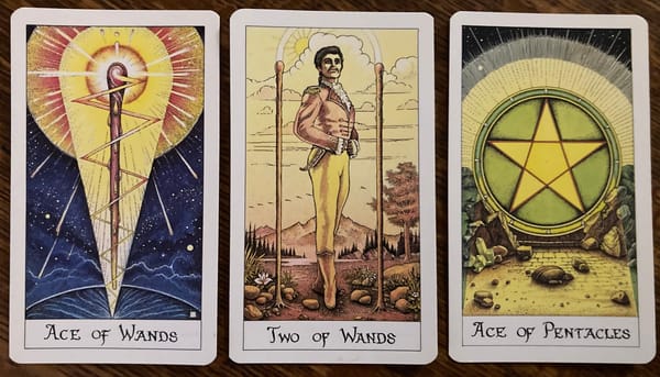 Three cards from the Cosmic Tarot deck: Ace of Wands, 2 of Wands, and Ace of Pentacles.